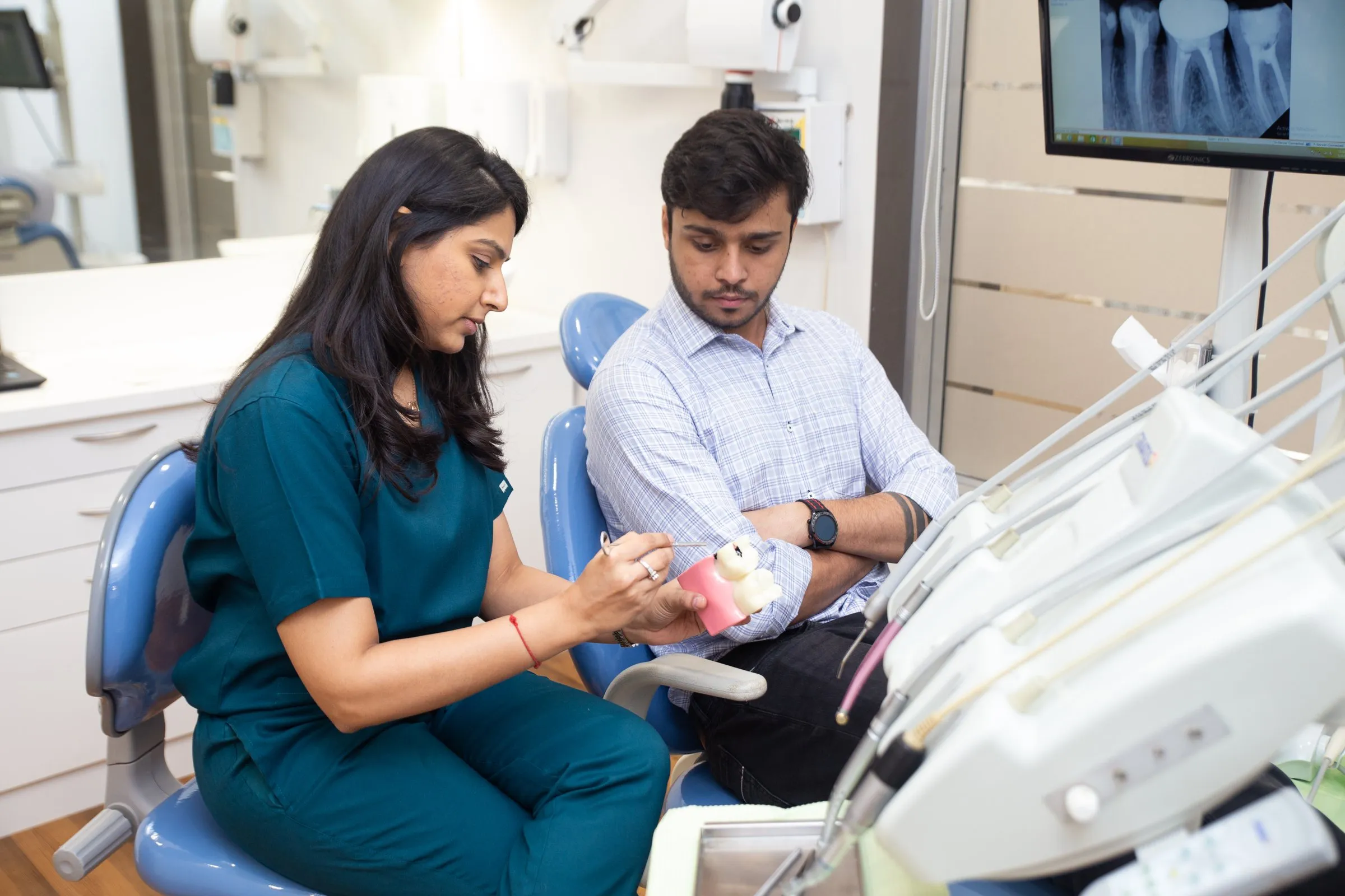 Dr. Upasana Gosalia explaining braces on a dental model at i-Smile Dental Clinic, Ghatkopar East